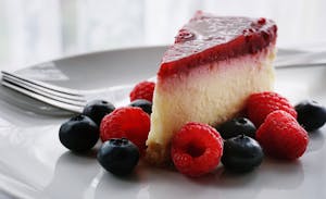 A Slice of Cheesecake with Strawberries and Blueberriese