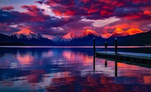 Dock Under Cloudy Sky in Front of Mountain